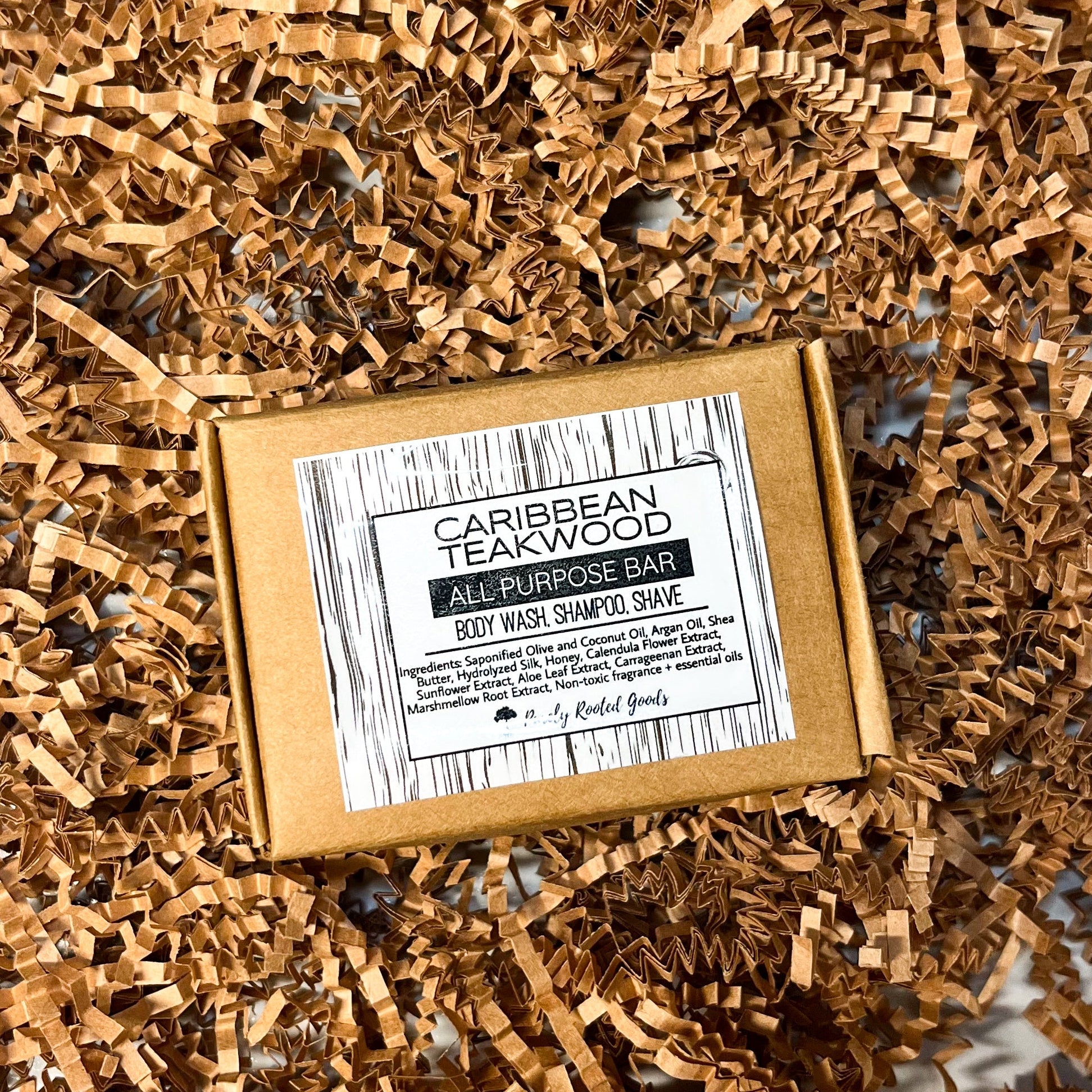 Bar of soap with a label on a bed of craft crinkle paper against a marble background