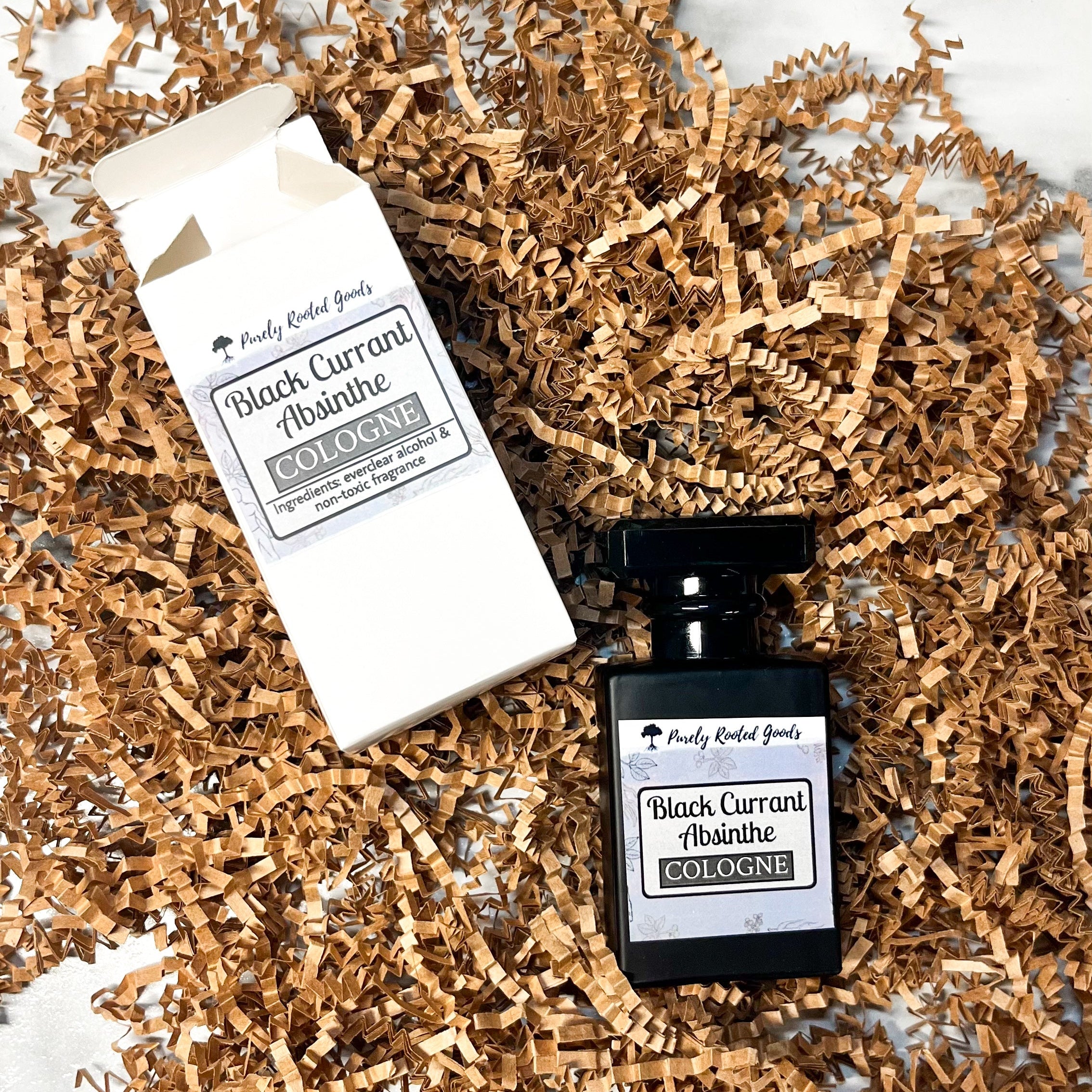 Black Currant Absinthe cologne bottle and packaging on a textured surface
