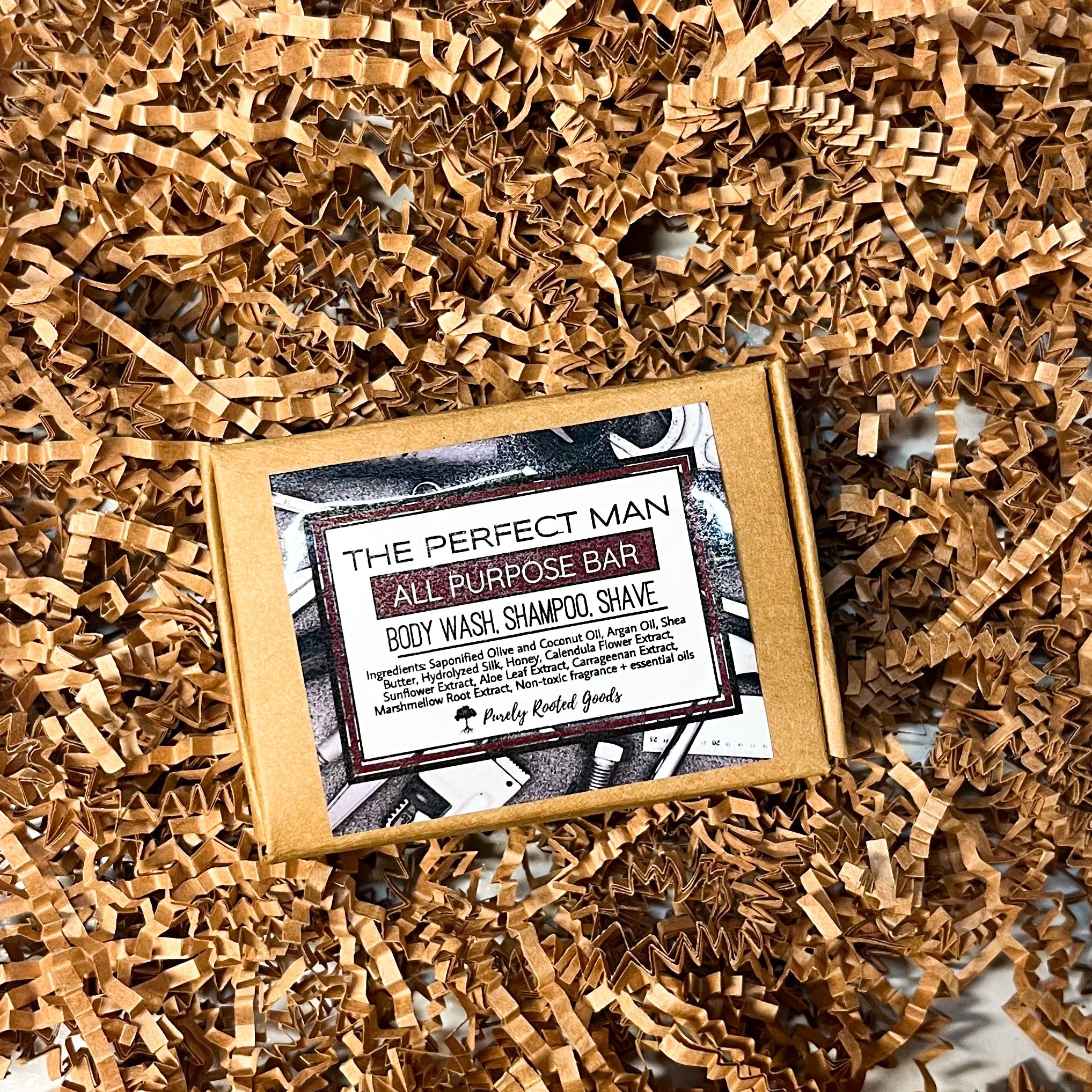 Bar of soap with a label on a bed of craft crinkle paper against a marble background